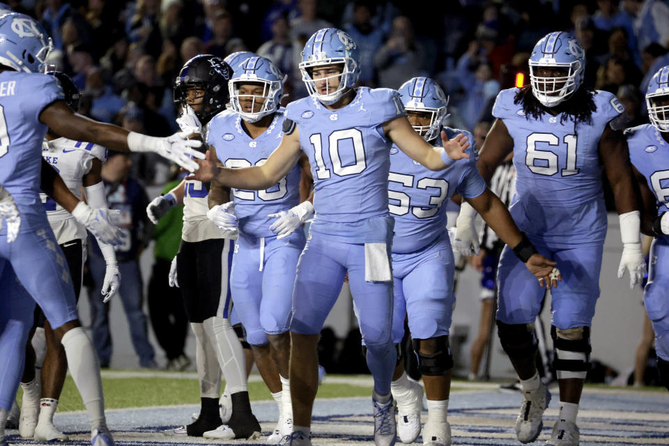 North Carolina quarterback Drake Maye (10) celebrates with teammates after scoring a touchdown against Duke during the first half of an NCAA college football game Saturday, Nov. 11, 2023, in Chapel Hill, N.C. (AP Photo/Chris Seward)