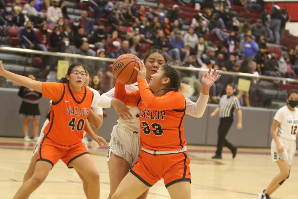 Gallup's Adreill Thomas circles around Shiprock's Demesia Young and puts up a shot in the second quarter of a district basketball game, Thursday, Feb. 9, 2023 at the Chieftain Pit.