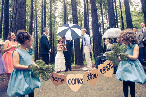 Flower girls carrying sign.