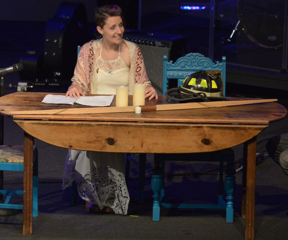 Liz Pieniazek reads a love letter from her husband at their kitchen table at the memorial service for Cincinnati firefighter and paramedic, Jordan Pieniazek, at Vineyard church in Springdale. He was killed May 1, 2016 as he drove his motorcycle to work.