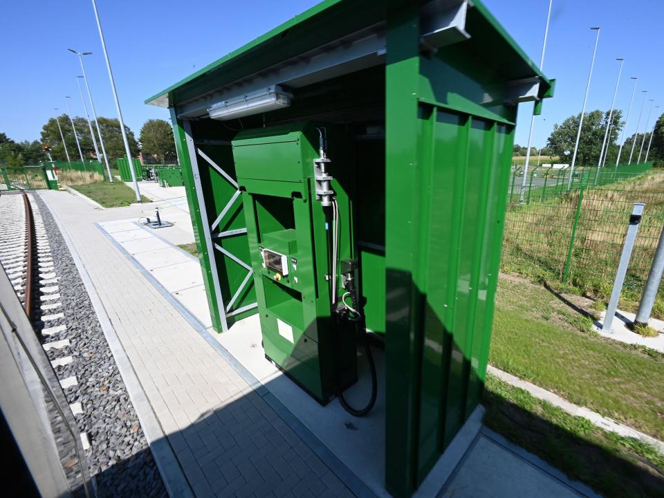 A hydrogen filling station for train powered entirely by hydrogen. the hydrogen station is painted green.