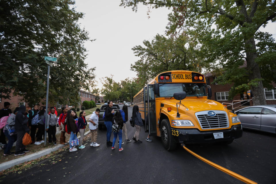 Middle school students line up to board the bus on Thursday, Oct. 10, 2019. 