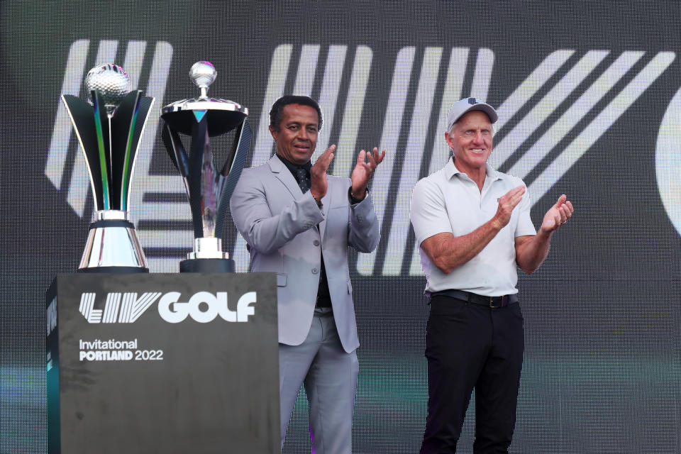 Majed Al Sorour (pictured left), CEO of Saudi Golf Federation, and Greg Norman (pictured right), CEO and commissioner of LIV Golf, clap during a trophy presentation.