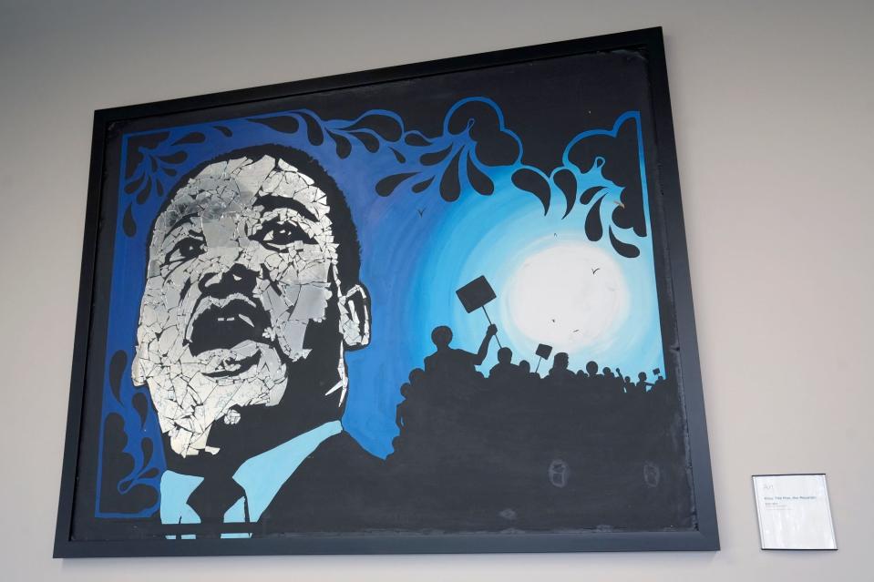 A piece of art comprised of glass on canvas by Walt Wali Neil, called "King: The Man, the Mountain," depicts Martin Luther King Jr., and hangs in the Columbus Metropolitan Library branch that now bears his name.