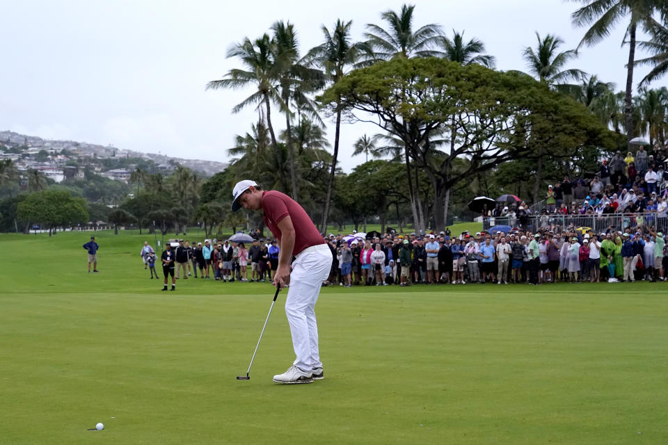 Cameron Smith makes his birdie putt on the 18th green to force a one-hole playoff against Brendan Steele during the final round of the Sony Open PGA Tour golf event, Sunday, Jan. 12, 2020, at Waialae Country Club in Honolulu. (AP Photo/Matt York)