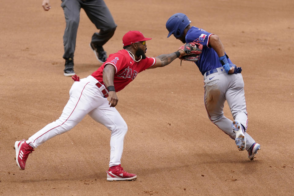 Texas Rangers' Marcus Semien, right, is tagged out by Los Angeles Angels second baseman Luis Rengifo after being caught between first and second while trying to steal second during the third inning of a baseball game Sunday, July 31, 2022, in Anaheim, Calif. (AP Photo/Mark J. Terrill)