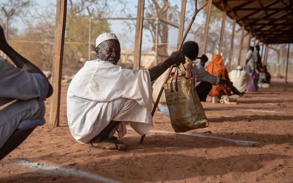 Sudanese refugees observe physical distancing while listening to health and sanitation messages over a speaker system at Ajuong Thok camp in South Sudan - Elizabeth Marie Stuart/UNHCR