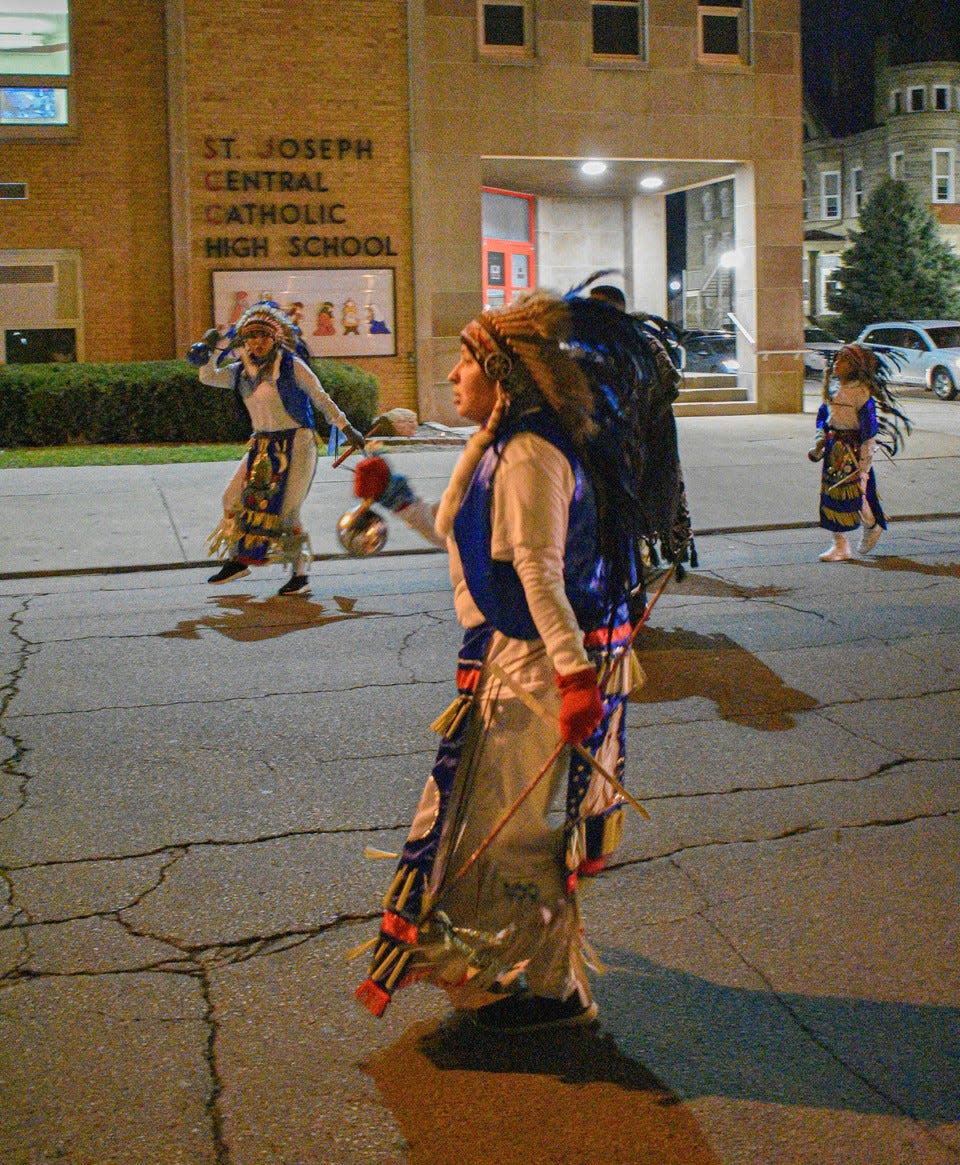 Matachines dancers pass by St. Joseph Central Catholic High School on their way to St. Joseph Church.
