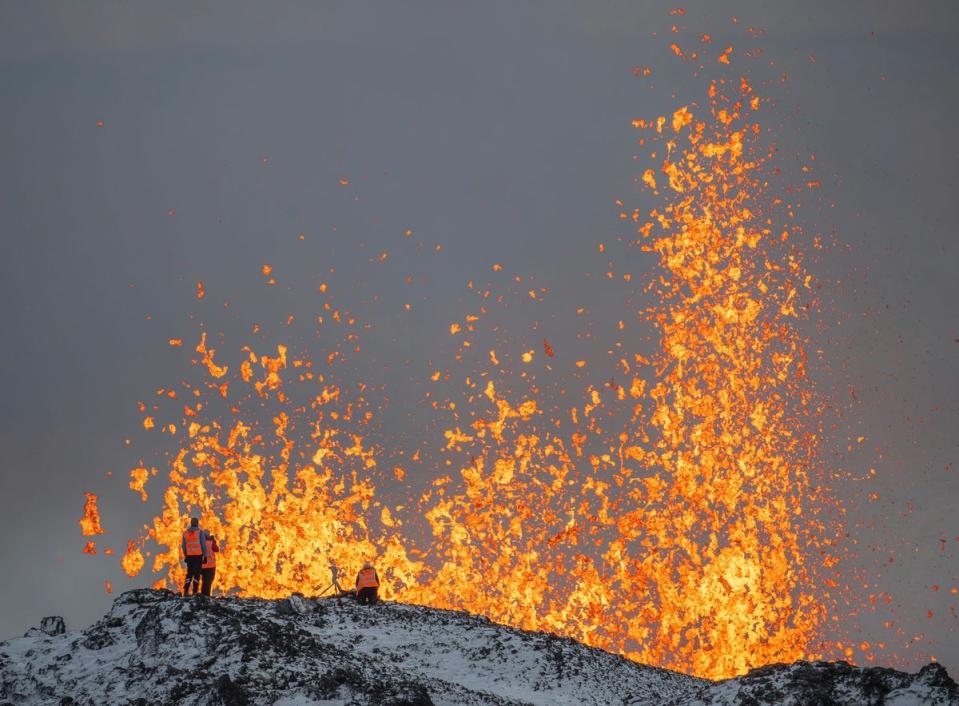 Scientists from the University of Iceland at the ridge of the volcano (AP)