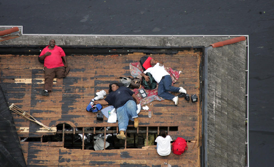 Residents wait on a roof top to be rescued from the floodwaters of Hurricane Katrina in New Orleans September 1, 2005. (David J. Phillip/Reuters)