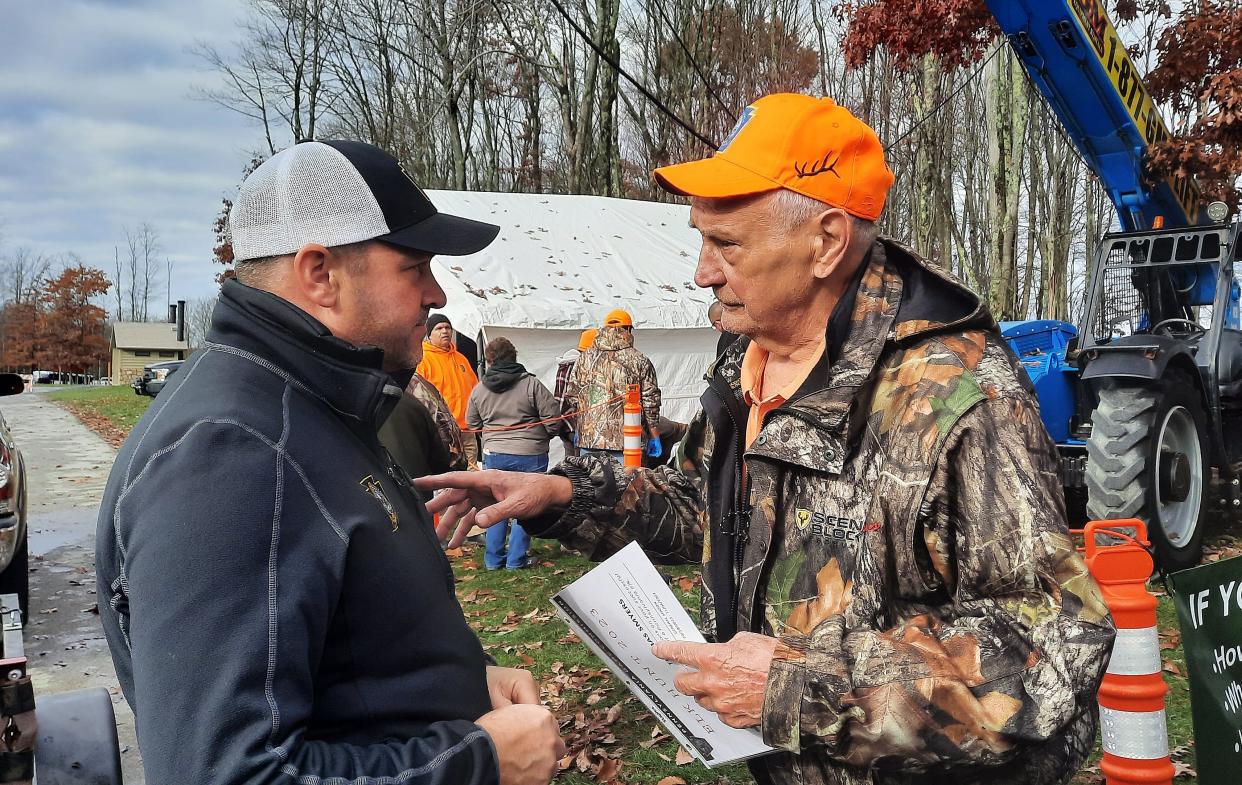 Jeremy Banfield, Pennsylvania Game Commission elk biologist, left, talks with Tom Smyers of Bedford Tuesday morning at the agency's elk check station at the Elk Country Visitor Center in Benezette. Smyers, 83, shot a bull elk Monday afternoon.