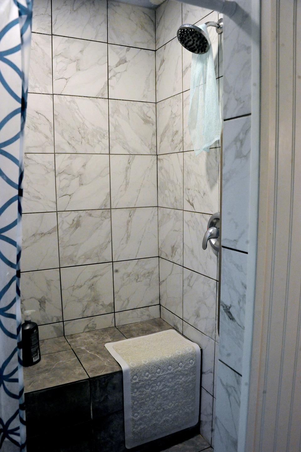 A new, specially-designed shower stall was among the home renovations funded by community donations.