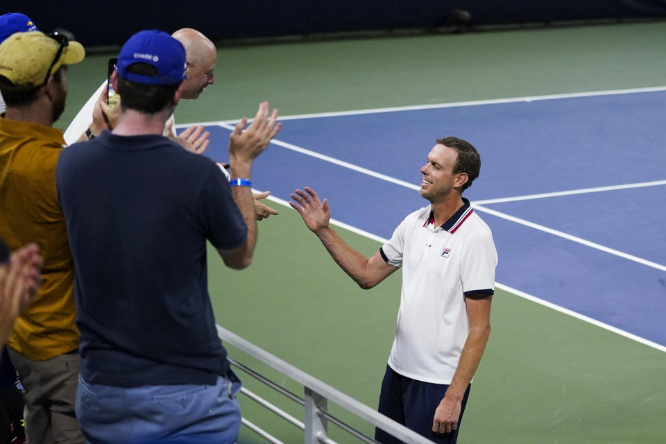 Sam Querrey, of the United States, is greeted by fans after a match Ilya Ivashka during the first round of the US Open tennis championships, Tuesday, Aug. 30, 2022, in New York. (AP Photo/Charles Krupa)