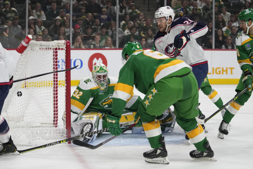 Minnesota Wild goaltender Filip Gustavsson (32) gives up a goal to Columbus Blue Jackets right wing Justin Danforth (not shown) during the first period of an NHL hockey game Saturday, Oct. 21, 2023, in St. Paul, Minn. (AP Photo/Abbie Parr)