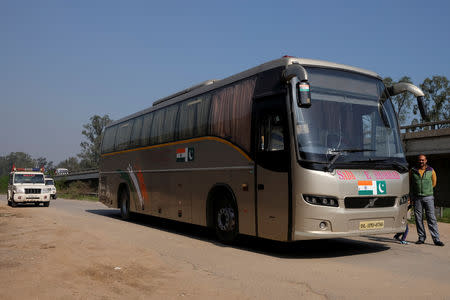 FILE PHOTO: Passengers disembark the India-Pakistan 'friendship bus' under police guard at a rest stop in Sirhind, India, March 15, 2019. REUTERS/Alasdair Pal