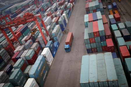 FILE PHOTO: A truck drives between shipping containers at a container terminal at Incheon port in Incheon