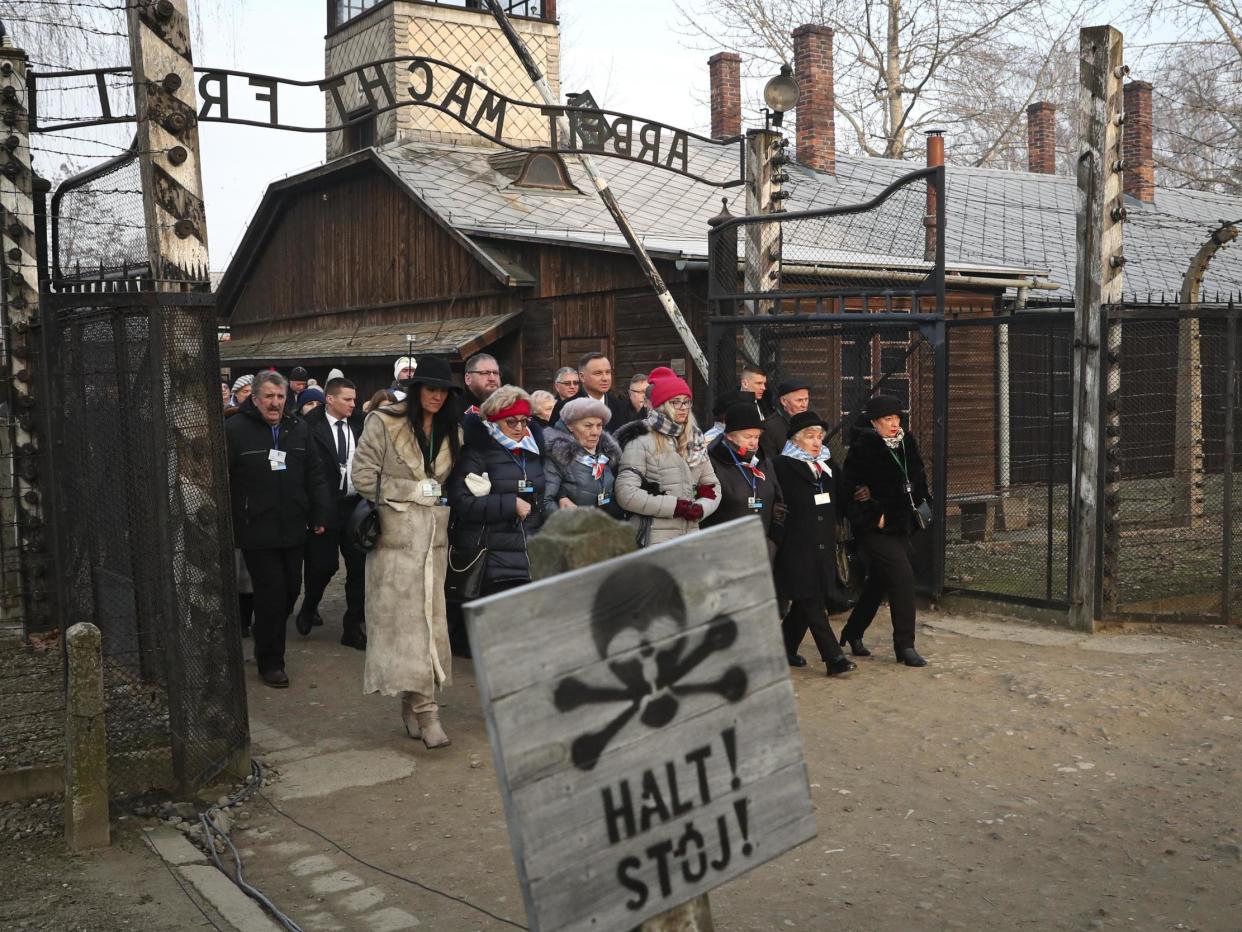 The president of Poland Andrzej Duda walks with survivors through the gates of Auschwitz to attend the 75th anniversary commemorations: AP