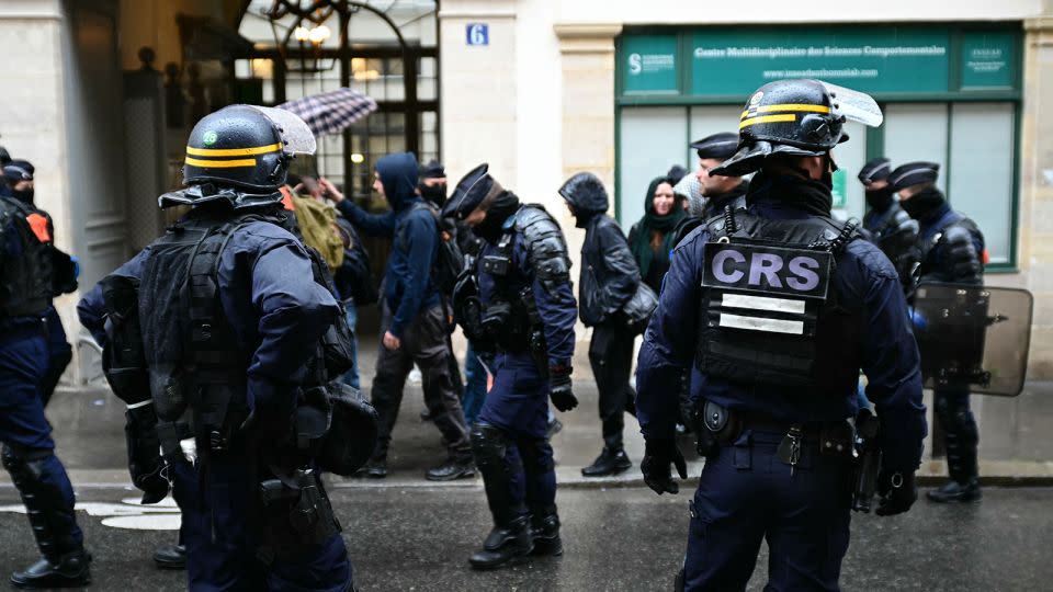 Riot police stand guard on the sidelines of a rally by university students in support of Palestinian people after a makeshift campement in front of the Sorbonne University was dispersed by police in Paris on May 2, 2024. - Miguel Medina/AFP/Getty Images