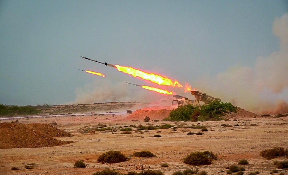 In this photo released Tuesday, July 28, 2020, by Sepahnews, missiles are fired in a Revolutionary Guard military exercise. Iran's paramilitary Revolutionary Guard fired a missile from a helicopter targeting the mock-up aircraft carrier in the strategic Strait of Hormuz. That's according to footage aired on state television on Tuesday. Iranian commandos also fast-roped down from a helicopter onto the replica in the footage from the exercise called "Great Prophet 14." The drill appears aimed at threatening the U.S. amid tensions between Tehran and Washington. (Sepahnews via AP)