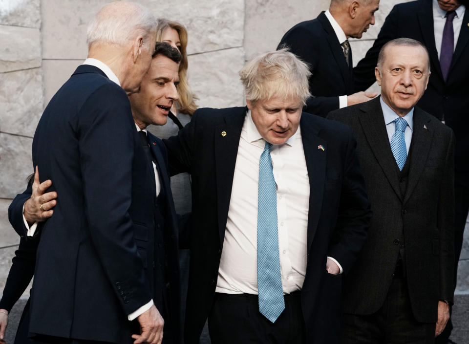 From left, U.S. President Joe Biden, French President Emmanuel Macron, British Prime Minister Boris Johnson and Turkish President Recep Tayyip Erdogan walk off the podium after a group photo during an extraordinary NATO summit at NATO headquarters in Brussels, Thursday, March 24, 2022. As the war in Ukraine grinds into a second month, President Joe Biden and Western allies are gathering to chart a path to ramp up pressure on Russian President Vladimir Putin while tending to the economic and security fallout that's spreading across Europe and the world. (AP Photo/Thibault Camus)