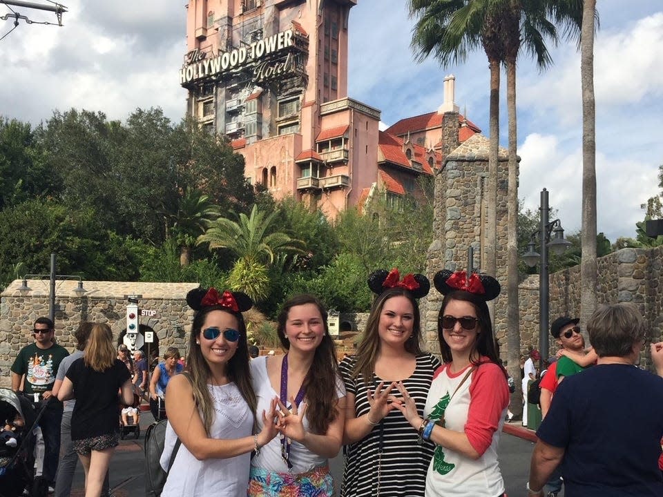 hayley and her friends posing in front of tower of terror at Hollywood studios