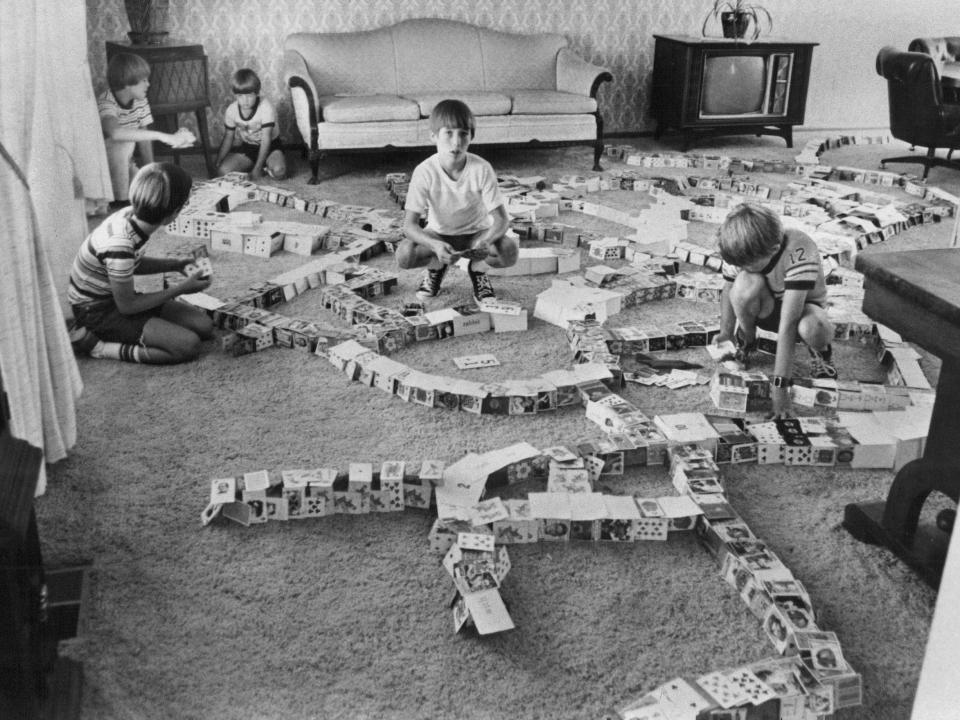 Five children attempt to break a record for the world’s largest train of cards in Denver in 1979.