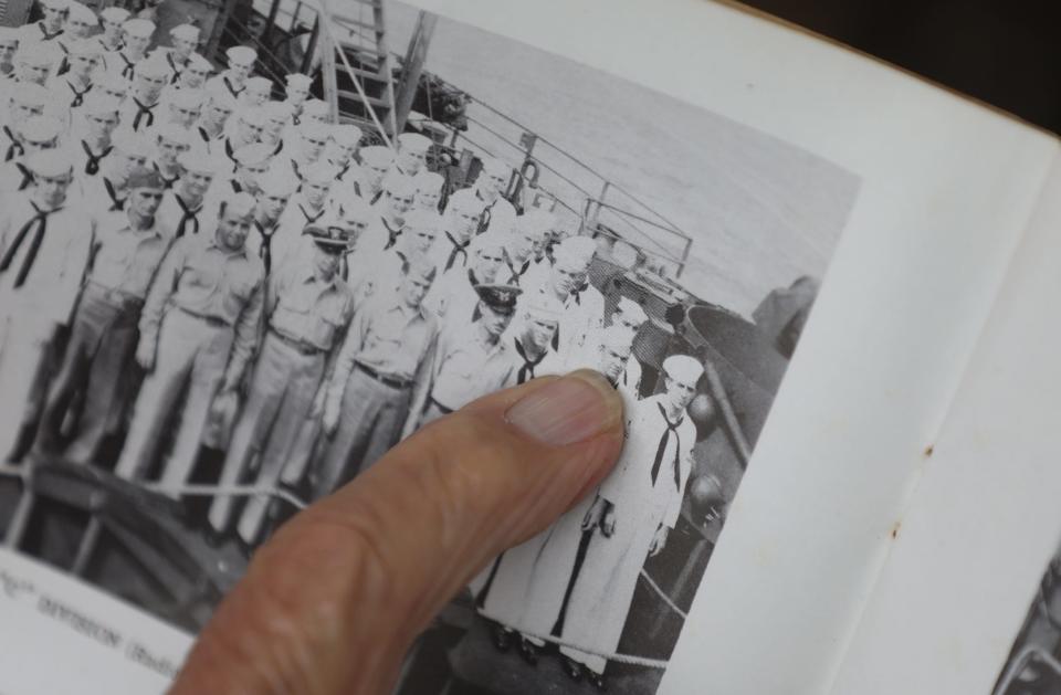 Bob Persichitti, 96, of Fairport, N.Y. points to a photo of himself when he served in the Navy where he was a radioman.