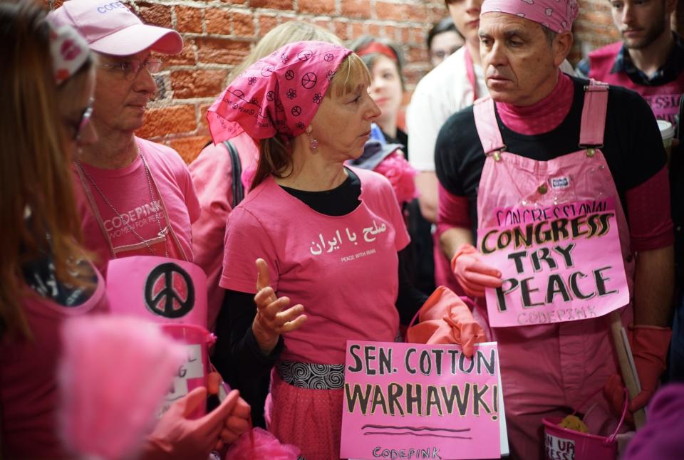 Code Pink peace activists discuss a letter to Iran's leaders written by Sen. Tom Cotton (R-Ark.) outside his office in the Russell Senate Office Building on Capitol Hill on March 19, 2015. The group organized a "spring cleaning of Congress."