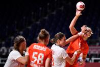 <p>Hungary's left back Noemi Hafra (R) is challenged by Norway's pivot Kari Brattset Dale (2ndR) during the women's quarterfinal handball match between Norway and Hungary of the Tokyo 2020 Olympic Games at the Yoyogi National Stadium in Tokyo on August 4, 2021. (Photo by Fabrice COFFRINI / AFP)</p> 