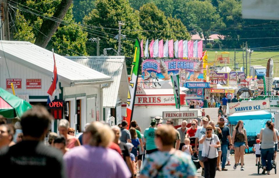 Visitors walk along Sharer Avenue on the first day of the Centre County Grange Fair on Friday, Aug. 19, 2022.