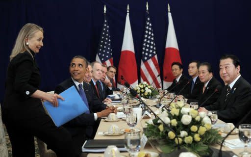 US President Barack Obama looks at US Secretary of State Hillary Clinton before the start of a bilateral meeting with Japanese Prime Minister Yoshihiko Noda (R) on the sidelines of the East Asian Summit at the Peace Palace in Phnom Penh on November 20, 2012