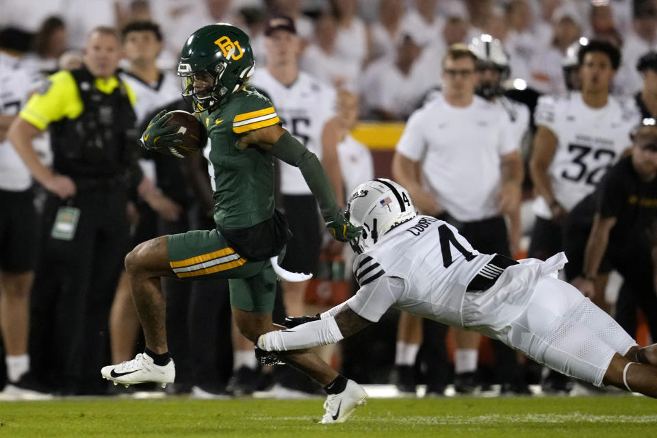 Baylor wide receiver Monaray Baldwin, left, runs from Iowa State defensive back Jeremiah Cooper, right, after catching a pass during the first half of an NCAA college football game, Saturday, Oct. 5, 2024, in Ames, Iowa. (AP Photo/Charlie Neibergall)