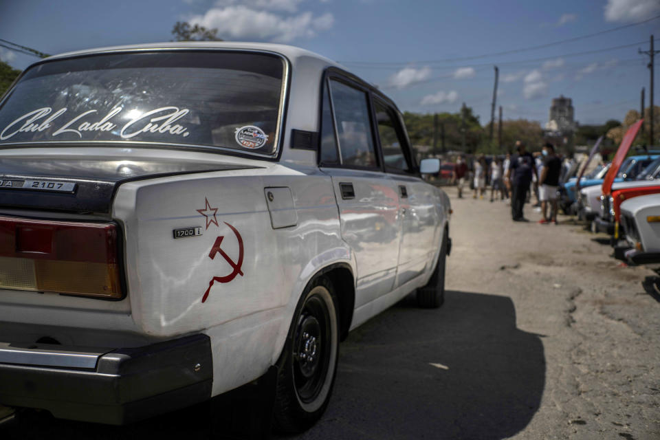 A Soviet-era Lada car with a hammer and sickle sticker is driven to the Lada Cuba Club meeting in Havana, Cuba, Sunday, March 21, 2021. Russians stopped making this model in September 2012, however, a line remained in production in Egypt until 2015. (AP Photo/Ramon Espinosa)