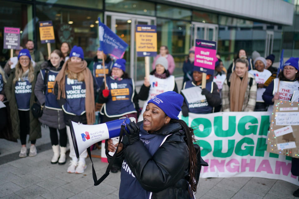 Members of the Royal College of Nursing (RCN) protest as nurses in England, Wales and Northern Ireland take industrial action over pay, outside the Queen Elizabeth Hospital in Birmingham, England, Tuesday, Dec. 20, 2022. (Jacob King/PA via AP)