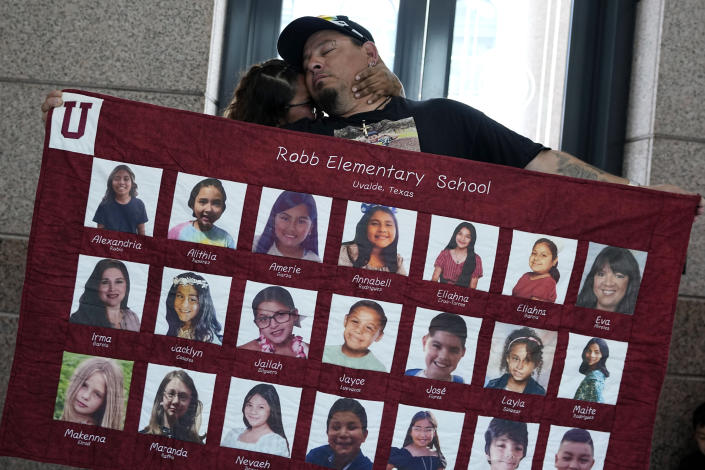 FILE - Abel Lopez, right, father of Xavier Lopez who was killed in the shootings in Uvalde, Texas, holds a banner honoring the victims after a Texas House committee voted to take up a bill to limit the age for purchasing AR-15 style weapons in the full House in Austin, Texas, Monday, May 8, 2023. For a year, ABC News kept a team in Uvalde. The result is a nuanced portrait of what happens over time to a suffering community, as seen in the two-hour documentary, “It Happened Here — A Year in Uvalde,” that airs first Friday on ABC and Saturday on Hulu. (AP Photo/Eric Gay, File)