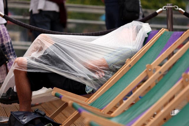 After Friday's scorching weather, the rain returned to Wimbledon on Saturday and one spectator was determined to keep dry 