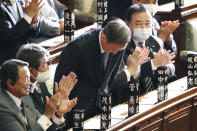 Yoshihide Suga bows after being elected as Japan's new prime minister at the parliament's lower house in Tokyo, Wednesday, Sept. 16, 2020. Suga was formally elected Wednesday as new prime minister in a parliamentary vote, replacing Shinzo Abe. (AP Photo/Koji Sasahara)