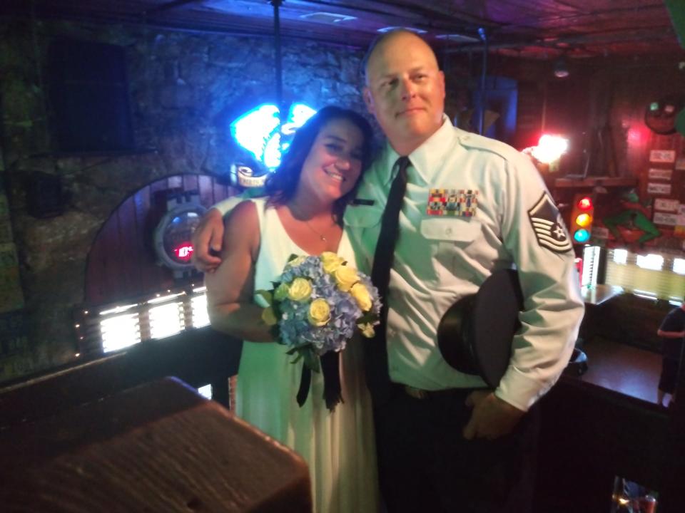Mel and Jim Lantz pose after exchanging wedding vows at Froggy's Saloon on Friday during Biketoberfest. The groom's parents were married in the same spot in 1986, they said.