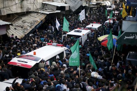 Mourners gather around ambulances carrying the bodies of seven Palestinian Hamas gunmen, who were killed when a tunnel collapsed close to the Gaza Strip's eastern border with Israel during their funeral in Gaza City, January 29, 2016. REUTERS/Suhaib Salem