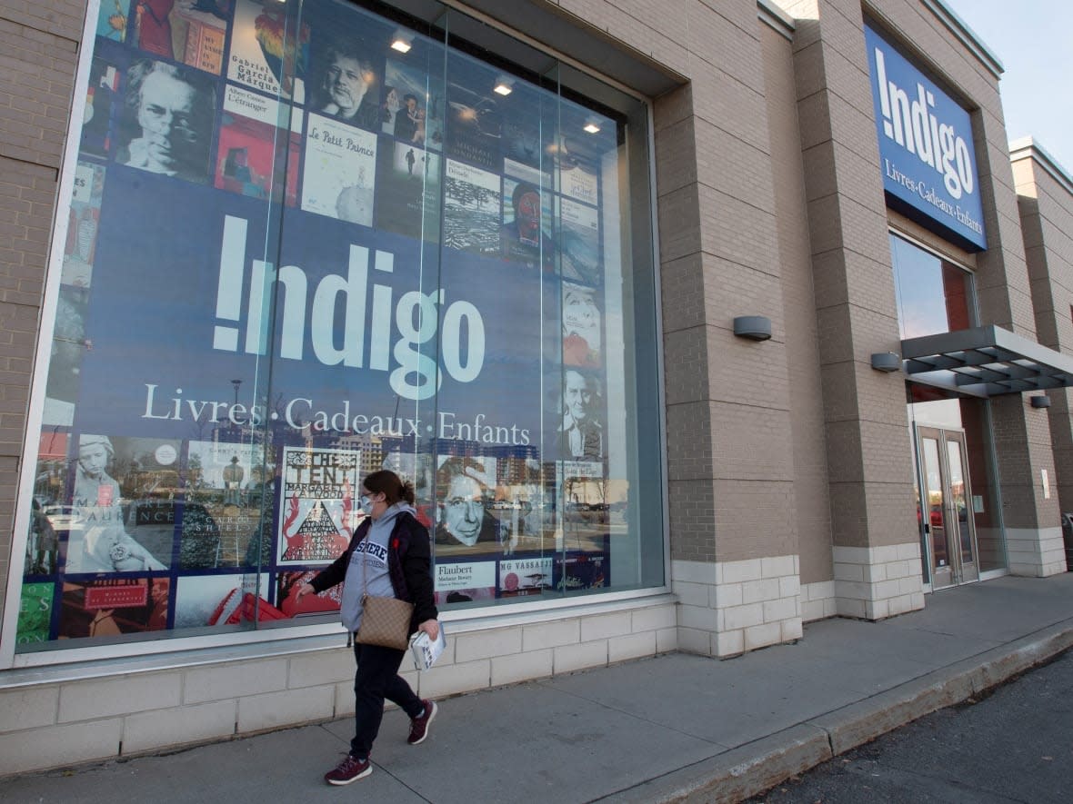 A woman walks past an Indigo bookstore in Laval, Que., on Nov. 4, 2020. The retailer has been hit by a 'cybersecurity incident' that is impacting sales online and in-store. (Ryan Remiorz/The Canadian Press - image credit)