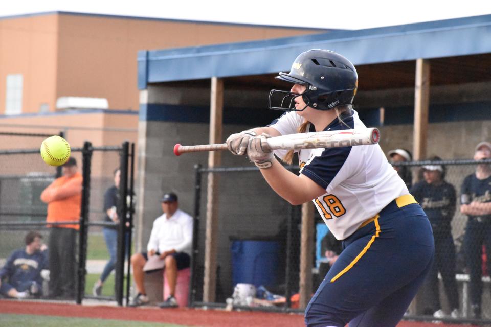 Mooresville's Liv Morris connects on a bunt attempt, eventually making it to first base during the Pioneers' rivalry matchup with Decatur Central on April 12, 2022.