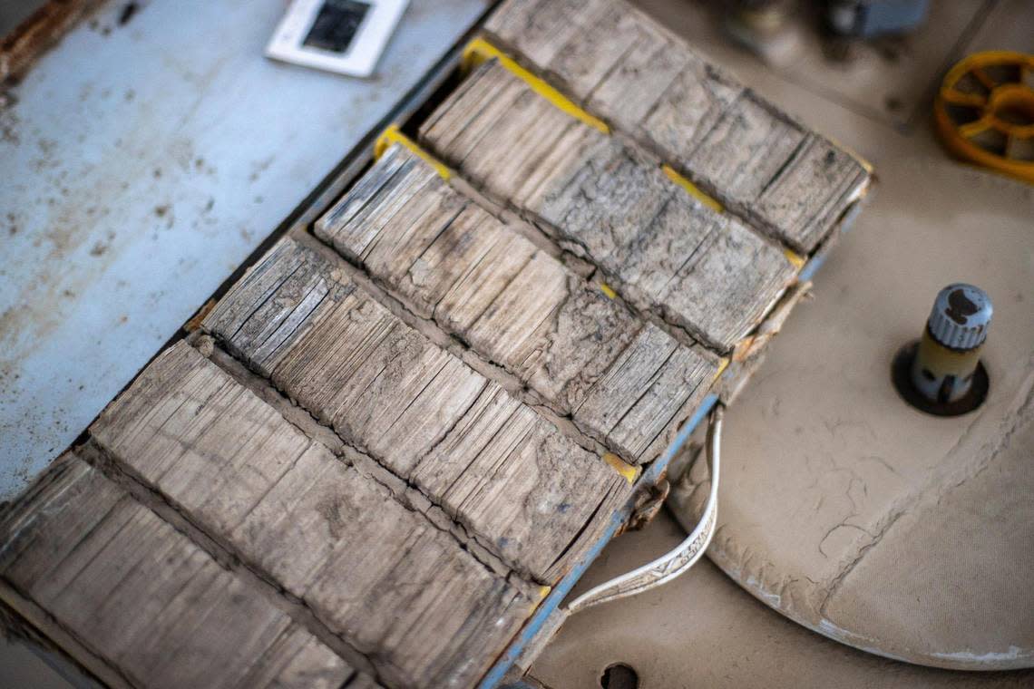 Photo slides and audio and video equipment covered in mud from last summer’s flooding sit outside Appalshop in Whitesburg, Ky., on Thursday, Dec. 8, 2022.