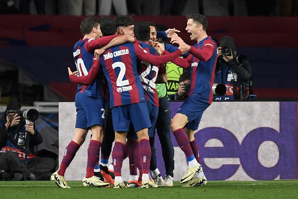 Barcelona players celebrate their third goal scored by Lewandowski, right (AFP via Getty Images)