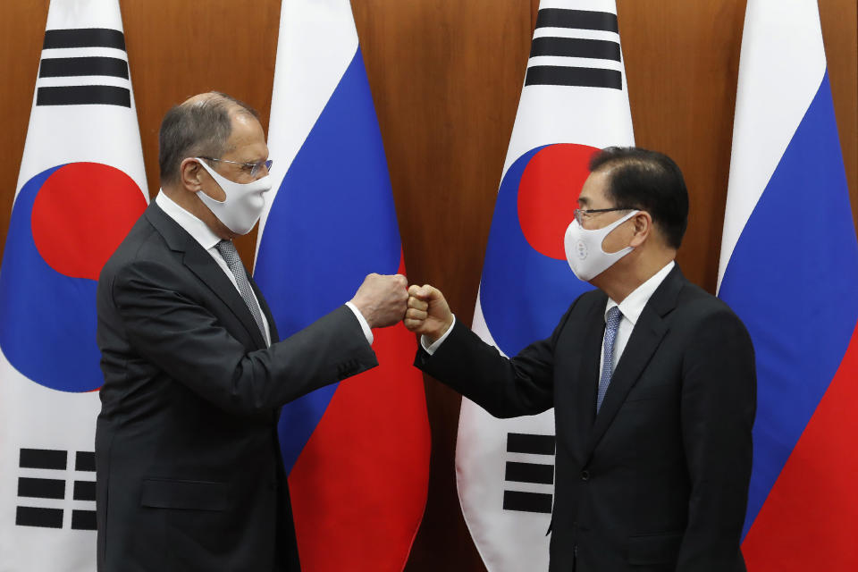 Russian Foreign Minister Sergey Lavrov, left, bumps elbows with South Korean Foreign Minister Chung Eui-yong after a joint announcement at the Foreign Ministry in Seoul, South Korea, Thursday, March 25, 2021. (AP Photo/Ahn Young-joon, Pool)