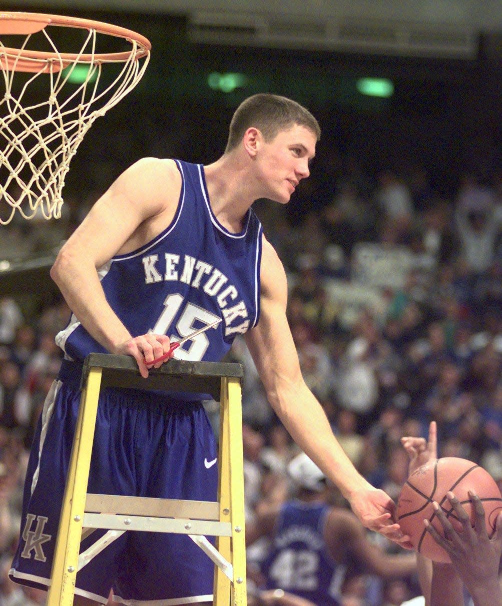 In this file photo, UK's Jeff Sheppard cuts down a piece of the net after the team beat Duke in St. Petersburg, Florida, to advance to the Final Four in 1998.