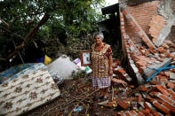 <p>Maria Guzman, 70, a housewife, poses for a portrait on the rubble of her house after an earthquake in San Jose Platanar, at the epicentre zone, Mexico, September 28, 2017. The house was badly damaged, but with the help of her family Guzman rescued some furniture. She lives in a shelter and hopes her home will be rebuilt. “The most valuable thing that I recovered was the photo of my wedding day,” Guzman said. (Photo: Edgard Garrido/Reuters) </p>