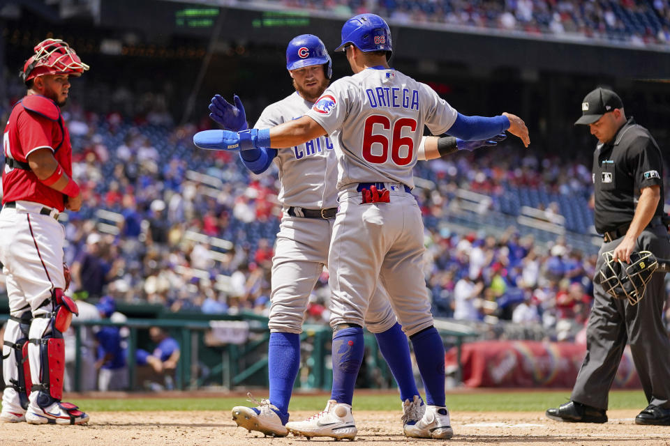 Chicago Cubs' Rafael Ortega (66) congratulates Chicago Cubs P.J. Higgins as he comes across the plate after hitting a two run home run during the fifth inning of a baseball game against the Washington Nationals at Nationals Park Wednesday, Aug. 17, 2022, in Washington. (AP Photo/Andrew Harnik)