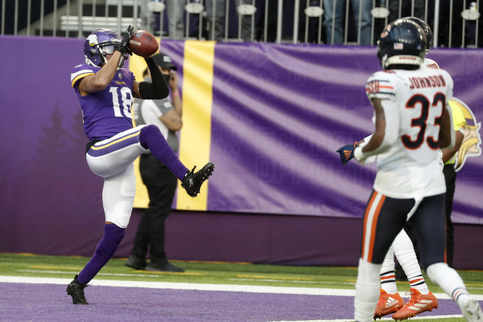 Minnesota Vikings wide receiver Justin Jefferson (18) catches a 45-yard touchdown pass ahead of Chicago Bears cornerback Jaylon Johnson (33) during the second half of an NFL football game, Sunday, Jan. 9, 2022, in Minneapolis. (AP Photo/Bruce Kluckhohn)