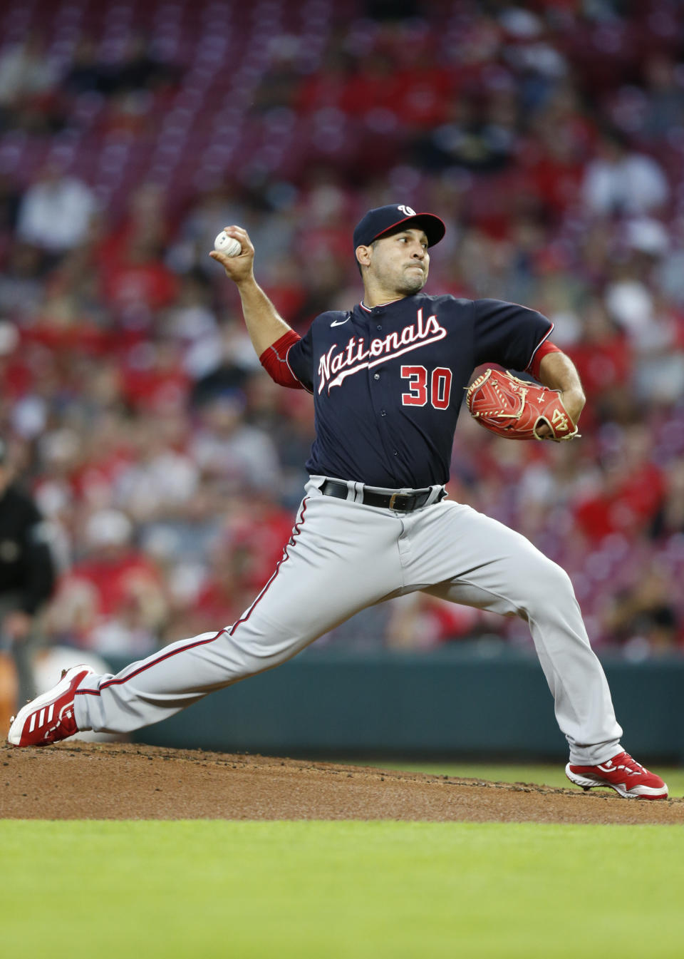 Washington Nationals pitcher Paolo Espino delivers to the Cincinnati Reds during the first inning of an MLB baseball game in Cincinnati, Friday, Sept. 24, 2021. (AP Photo/Paul Vernon)