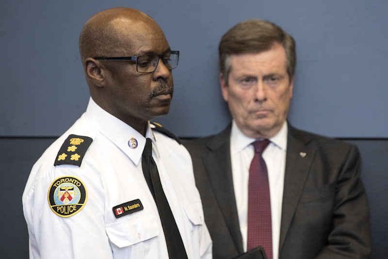 Toronto Police Chief Mark Saunders, left, and Toronto Mayor John Tory are seen here on April 24, 2018. The two leaders have committed to add more police officers to city streets as part of a temporary measure to combat gun violence in Toronto.